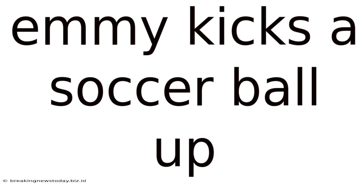 Emmy Kicks A Soccer Ball Up